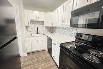A kitchen with black appliances 